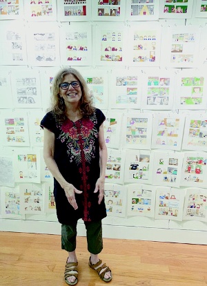 The author in front of art from Why Is Everybody Yelling?
